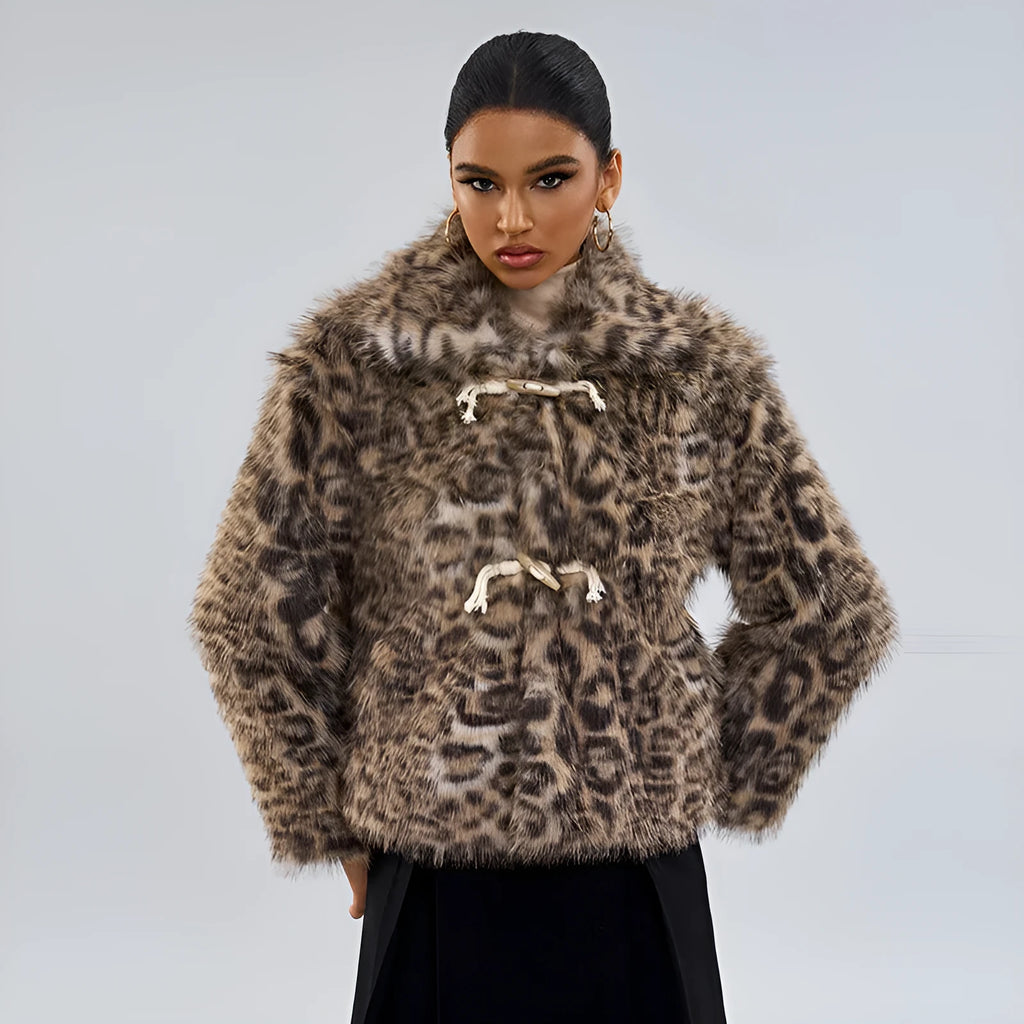 Women's leopard print coat with a buckle on the lapel collar, shown in street fashion style.