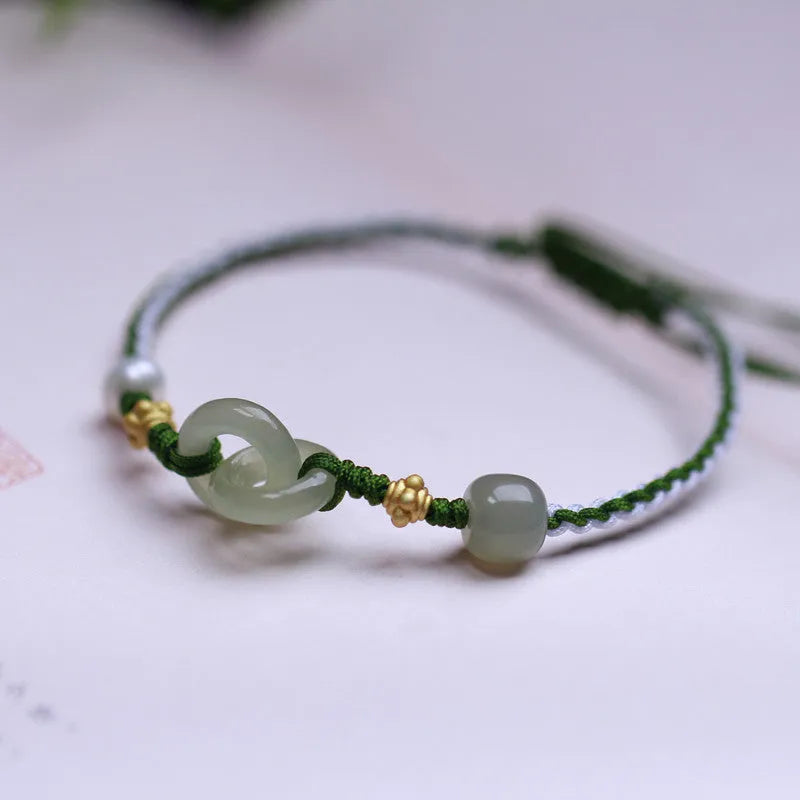Natural Hetian jade pendant on woven wire bracelet with hollow-out design