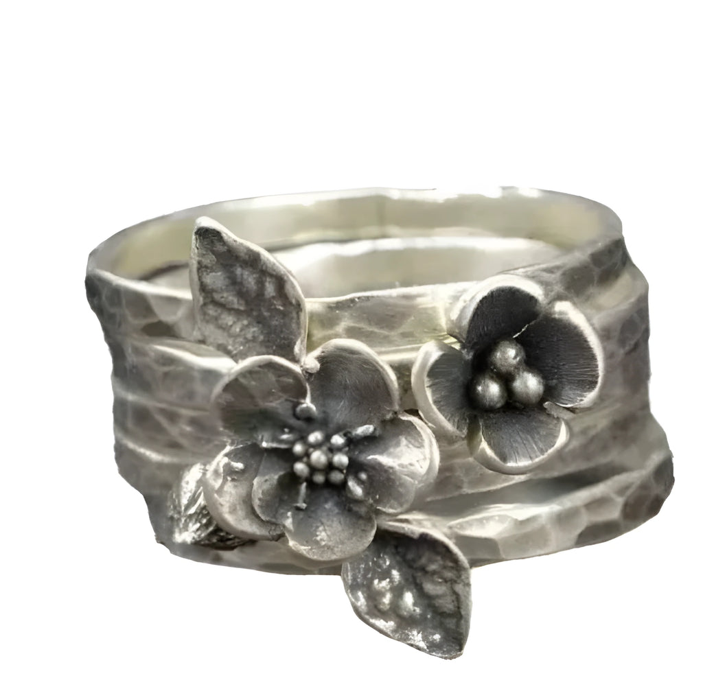 Silver alloy ring with carved honeycomb and bee flower shape on white background