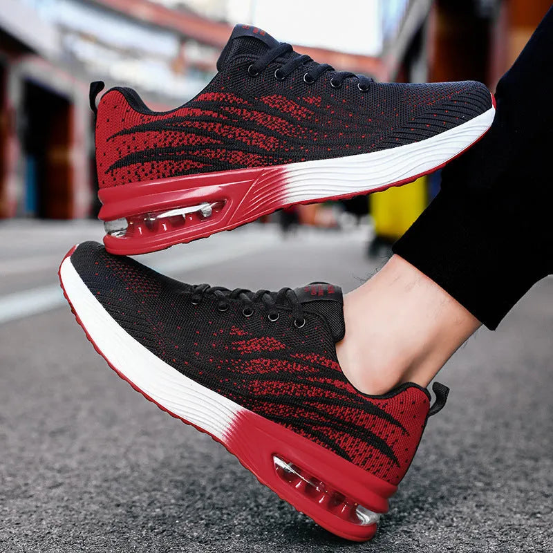 Men's air cushion casual running shoes in black and red with flyknit upper and wedge heel on white background