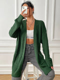 A dark green loose-fit women's cardigan sweater with two front pockets and long sleeves.