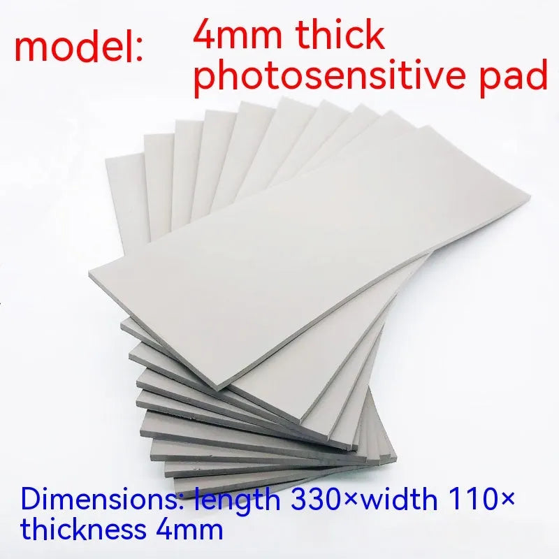 Black and grey plastic light-sensitive mat for calligraphy seals, showing 330mm by 110mm size.