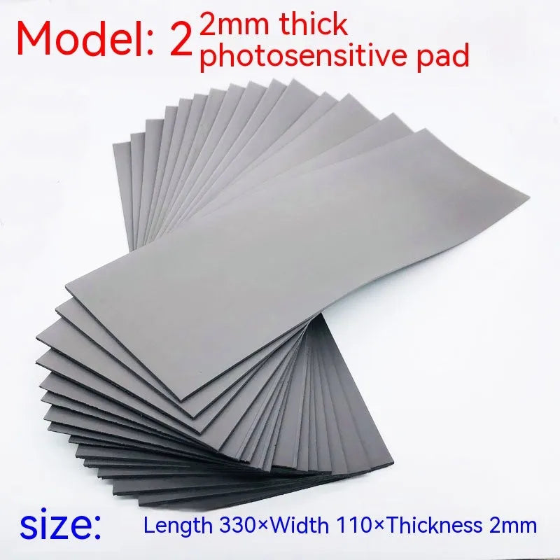 Black and grey plastic light-sensitive mat for calligraphy seals, showing 330mm by 110mm size.