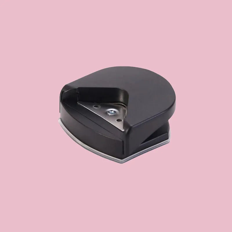 Black plastic and metal business card corner cutter on a white background.