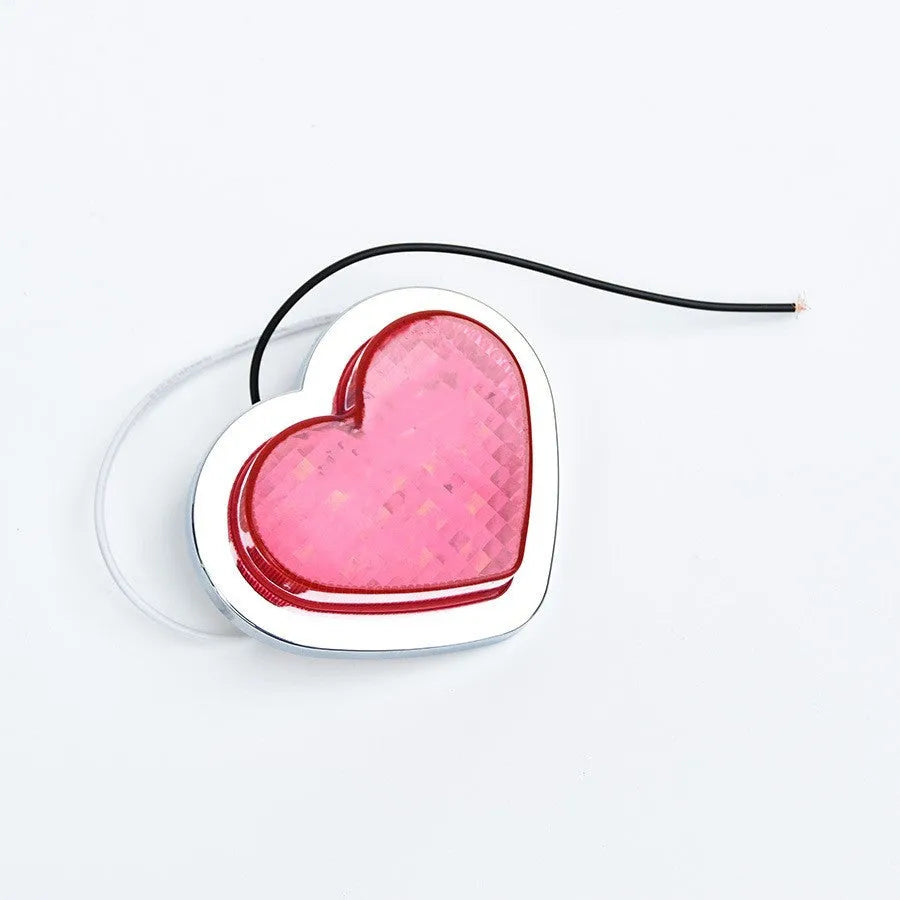 Heart-shaped red LED automotive sidelight mounted on car fender