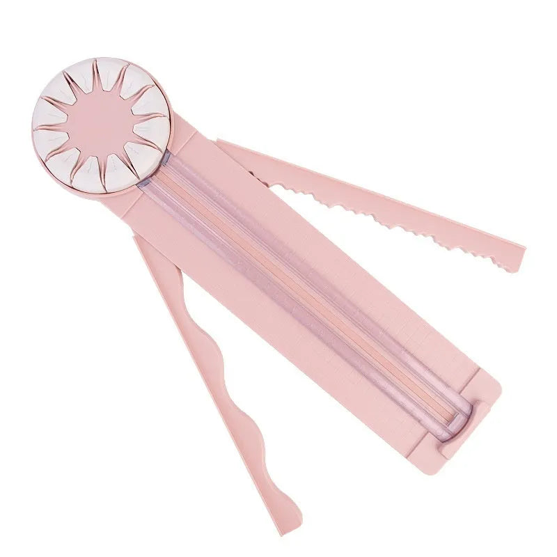 Pink and black 12-in-1 decorative edge paper cutting machine for A4 paper on a desk.