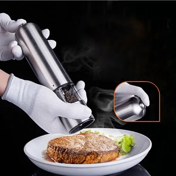 Electric stainless steel pepper grinder with natural colour finish on a kitchen counter