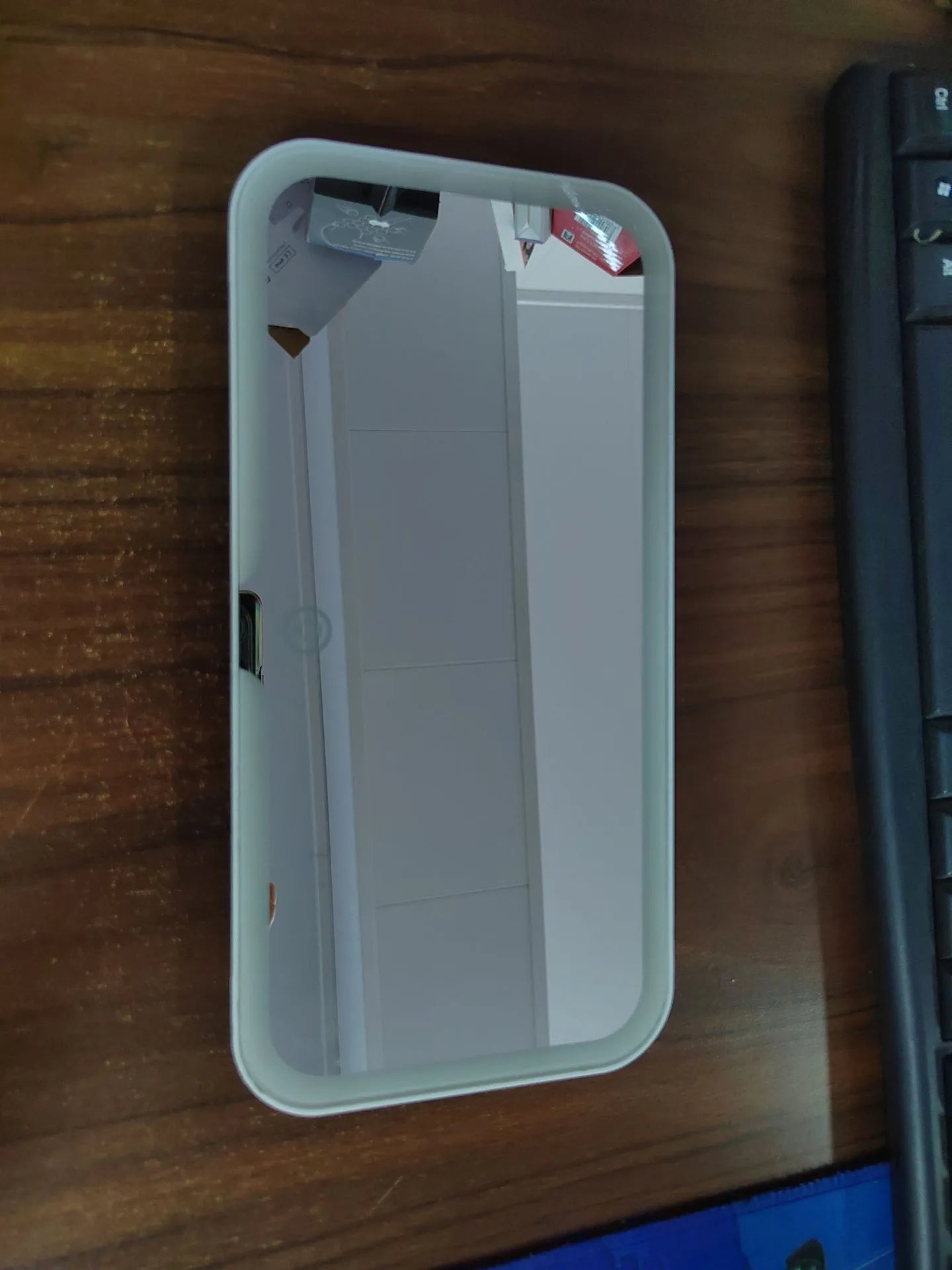 White ABS car sun visor mirror with LED lights and aluminium lens for make-up application.