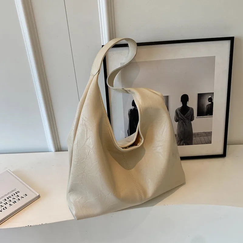 Soft leather large capacity casual shoulder bag with zip closure in multiple colour options.