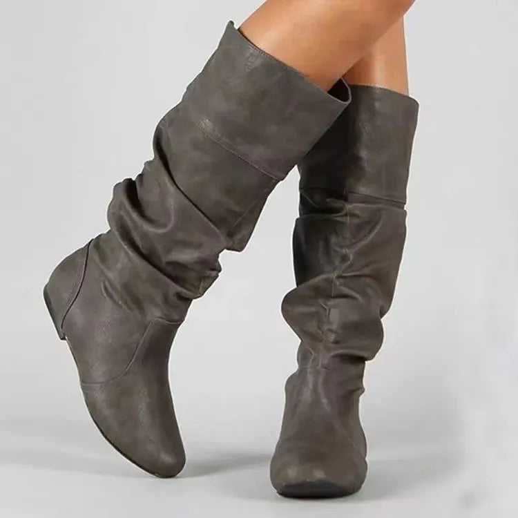 Women's flat heel knee-high slip-on boot in black with round toe and rubber sole