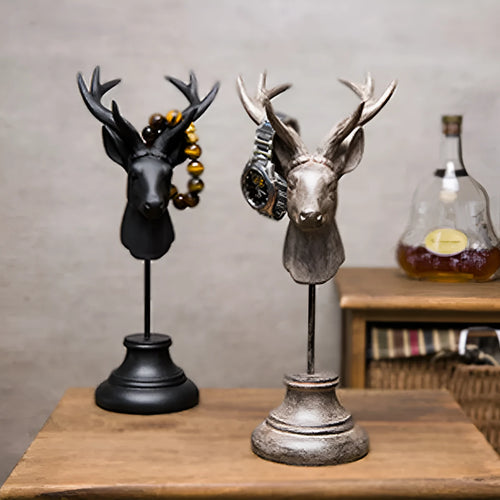 A tall black animal-shaped decorative ornament made from natural resin on a wooden shelf.