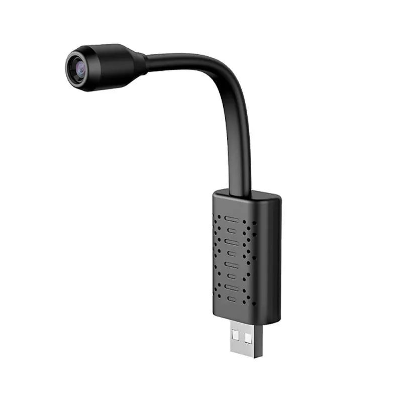 Compact matte black V380 wireless USB security camera on a shelf with a microSD card and USB cable.