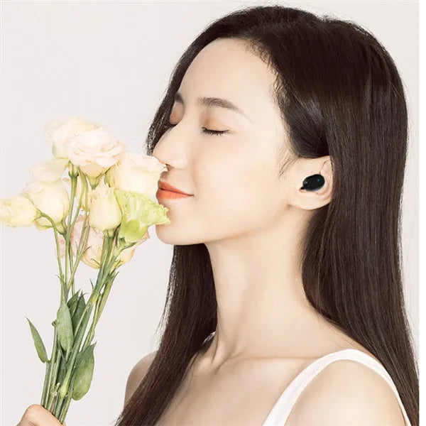 M1 Bluetooth wireless headset with black earbuds showing bilateral stereo design