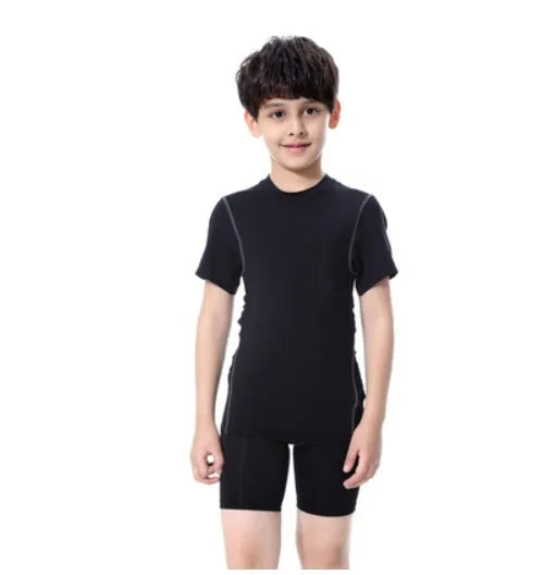 Children's black and green polyester-spandex sportswear set with T-shirt and trousers.