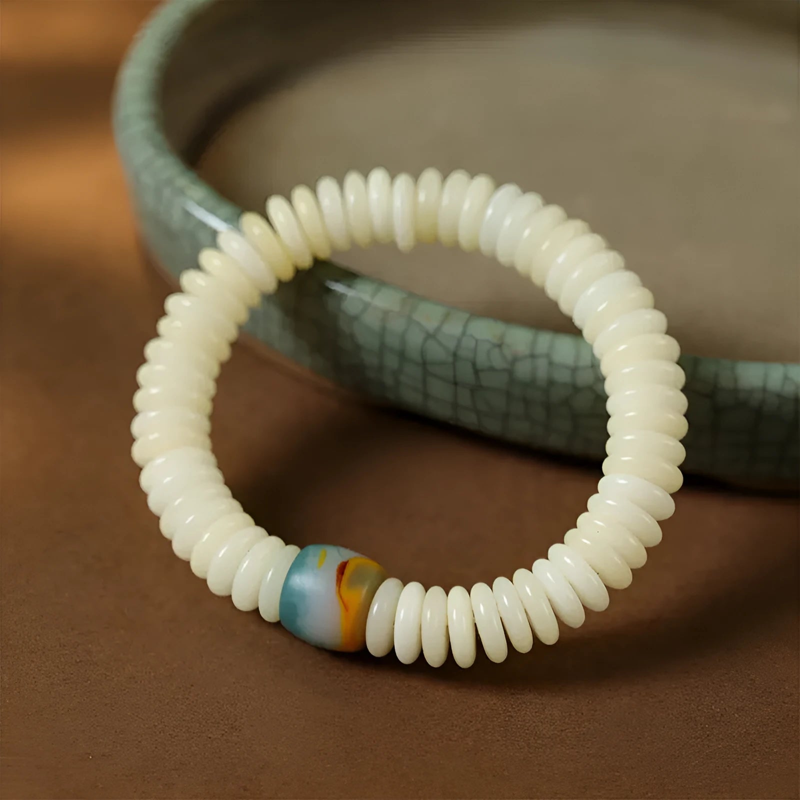 Close-up of a White Bodhi seed bracelet showing its 3x10mm beads and string.