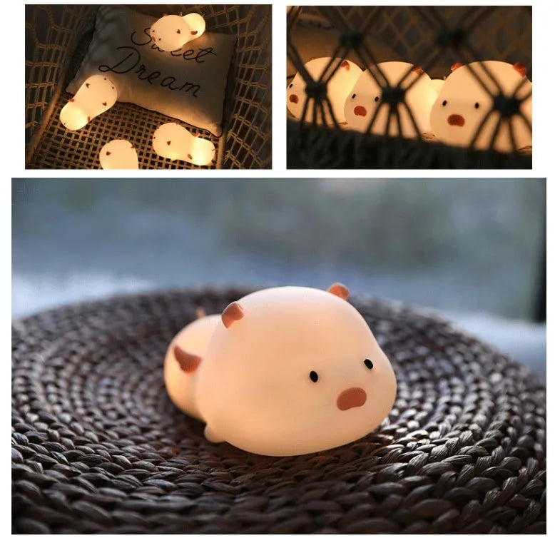 Blue or pink pig silicone night light with sleeping design, shown with dimensions and rechargeable battery.