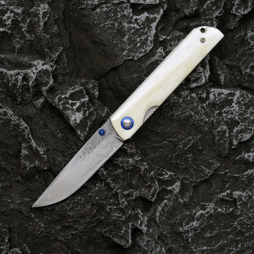 Damascus steel folding knife with black finish and ox bone handle, blade open showing 8.5cm cutting edge