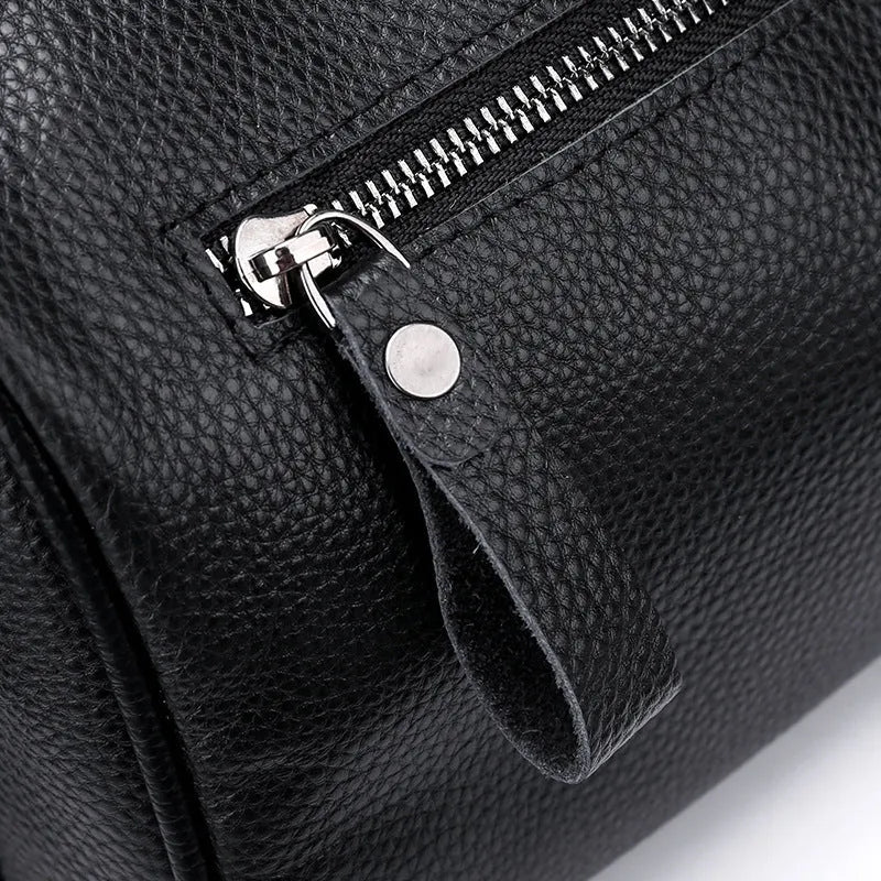 Black genuine leather crossbody bag with dimensions 24x16x13cm showing large capacity and polyester lining
