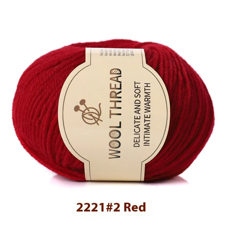 One roll of beige domestic wool hand-knitting yarn for size 10 needles next to knitting needles.