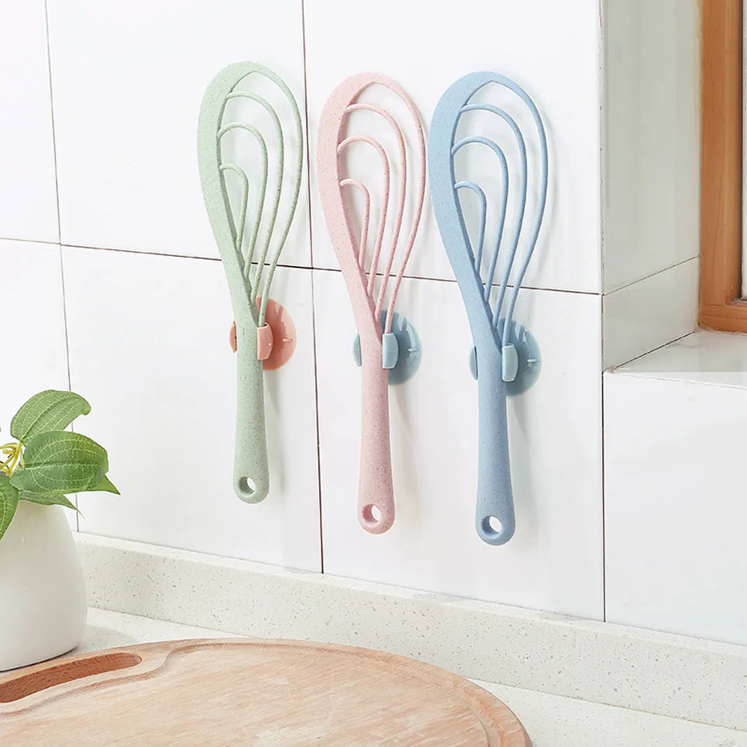 PVC rice scoop 19cm with suction cup holder in blue mounted on a white wall