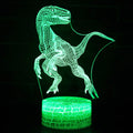 Colourful dinosaur-themed 3D night light with remote control on a table