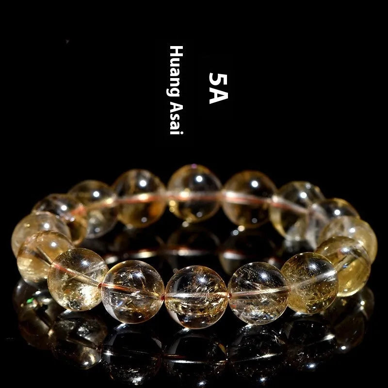 Natural yellow citrine bracelet with geometry-shaped beads in various sizes on a wrist.