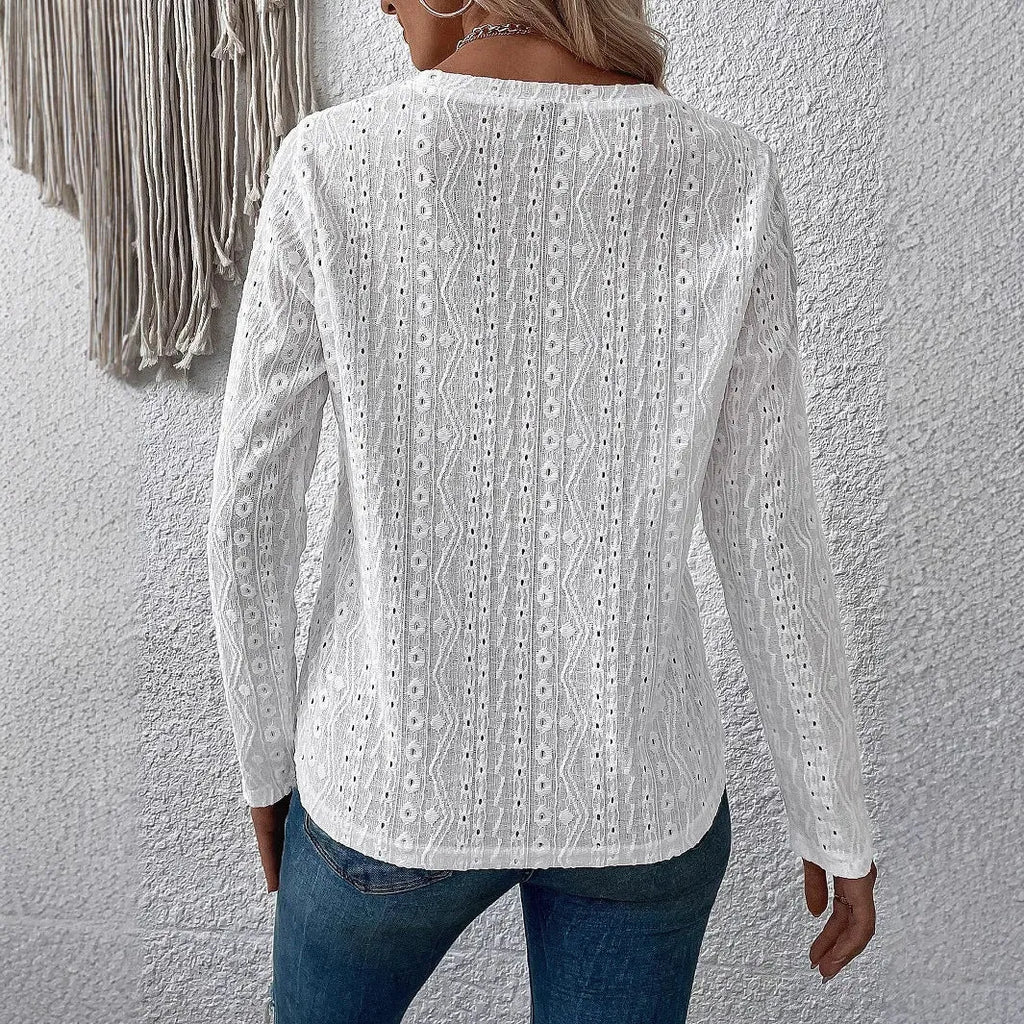 White loose fit long sleeve round neck t-shirt on a hanger.
