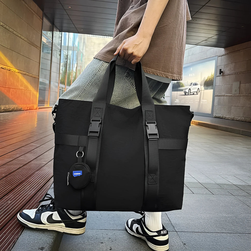 Men's grey Oxford cloth travel shoulder bag showing large main compartment and separate coin purse.