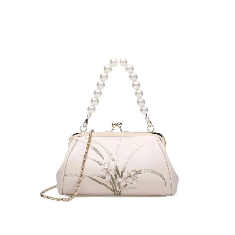 Beige women's embroidered shoulder bag with shell shape design made from soft PU leather