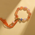 Vintage Tibetan agate bracelet with floral and geometric patterns including lily motif
