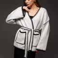 Loose lace-up knitted cardigan in camel colour, showing mid-length fit and long sleeves.