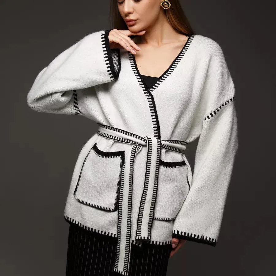 Loose lace-up knitted cardigan in camel colour, showing mid-length fit and long sleeves.