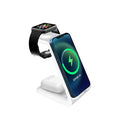 White upright wireless charging stand holding a mobile phone, with a smartwatch and earbuds case charging on its base.