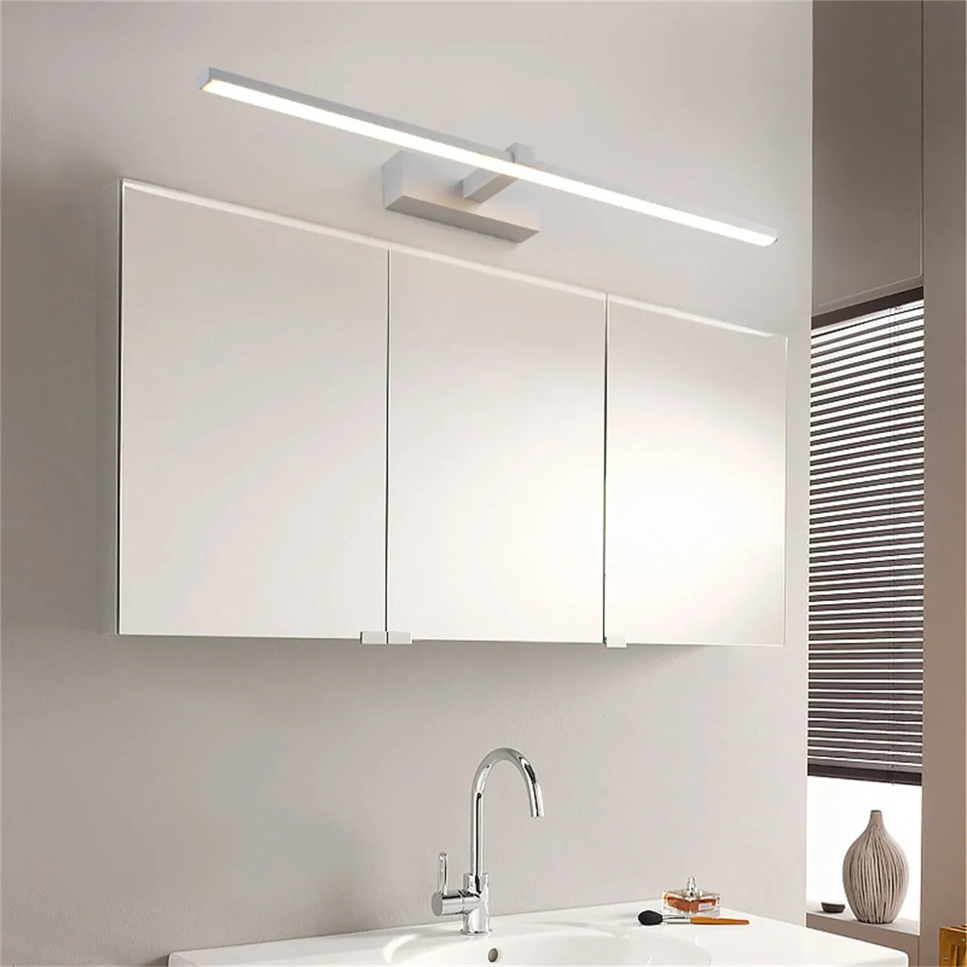 60x8cm black LED bathroom wall lamp with push button switch mounted above a vanity mirror