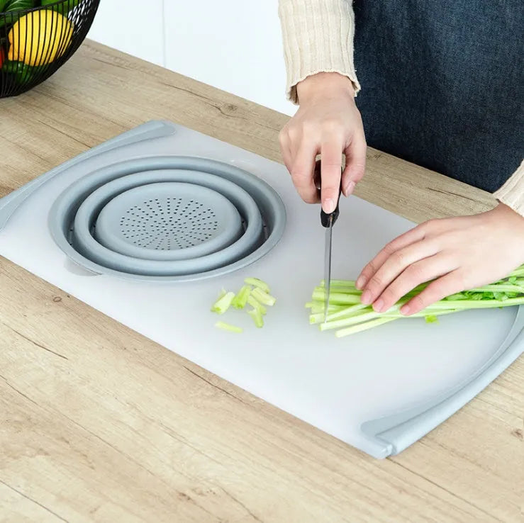 Grey folding chopping board with detachable drain basket showing 50cm cutting surface