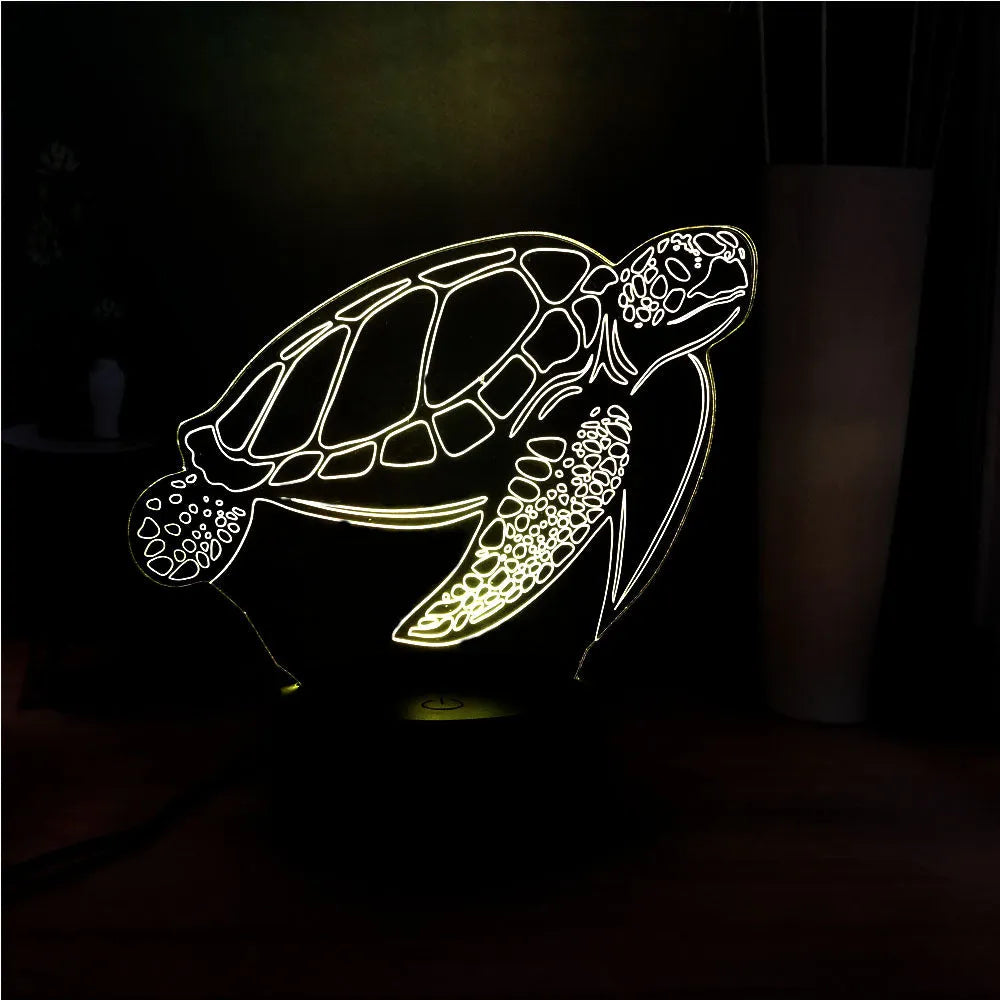 3D acrylic turtle-shaped LED night light with multi-colour illumination on a wooden surface.