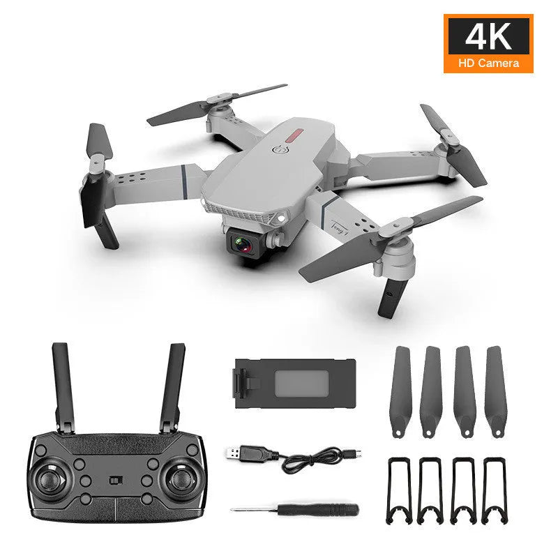 Grey foldable remote control drone with dual 4K cameras, LED lights, and a handheld transmitter.
