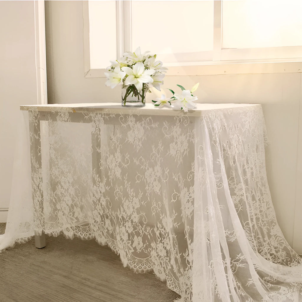 White embroidered lace tablecloth made from nylon yarn, 150x300cm, laid flat on a table with decorative pattern visible.