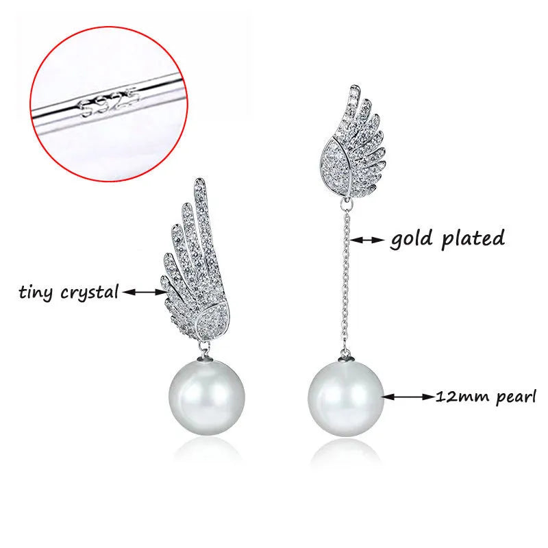 Sterling silver angel wing drop earrings with gold-plated stone inlay and diamond-cut texture.