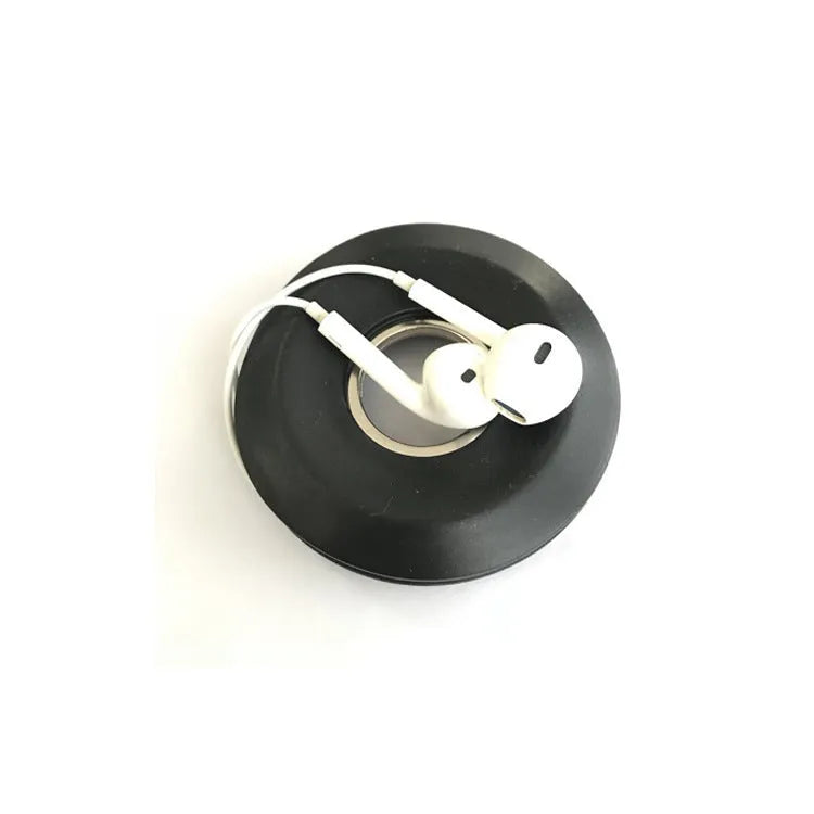 Silicone donut cord reel with suction cup and magnet for organising mobile phone and headphone cables