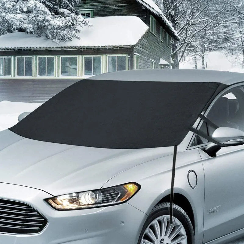 Black rubber Oxford cloth windshield ice and snow gown draped over car windscreen in winter