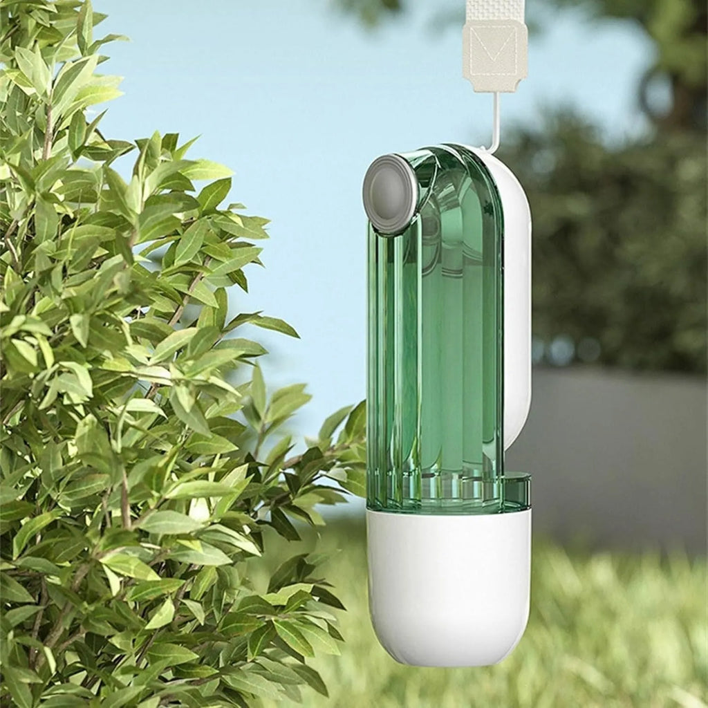 Beige and green foldable dog water bottle with food dispenser for outdoor use.