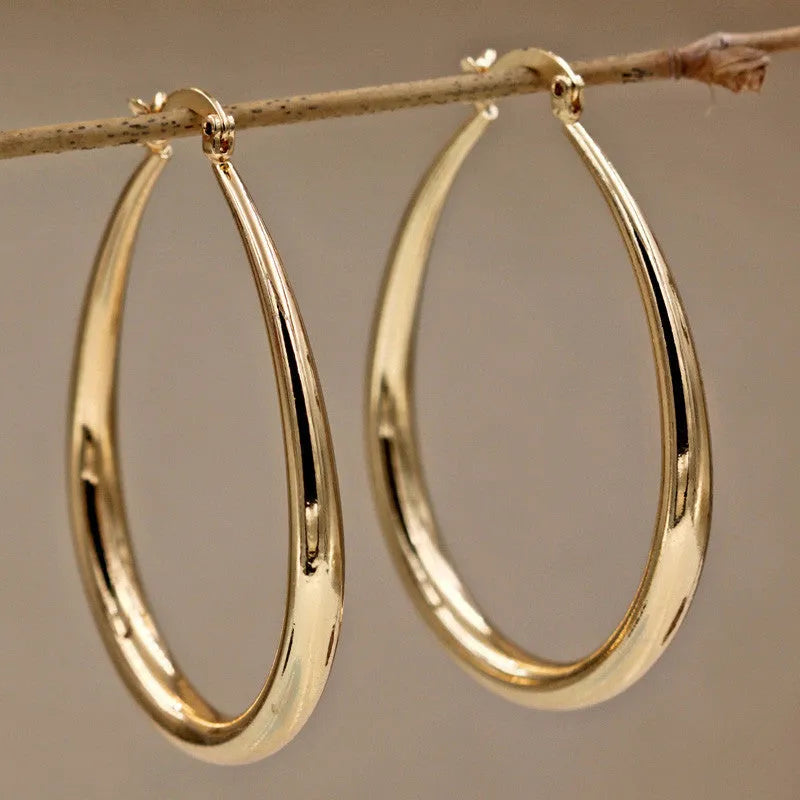 Geometric oval metal earrings for women with electroplated finish and alloy inlaid gems in gold and silver