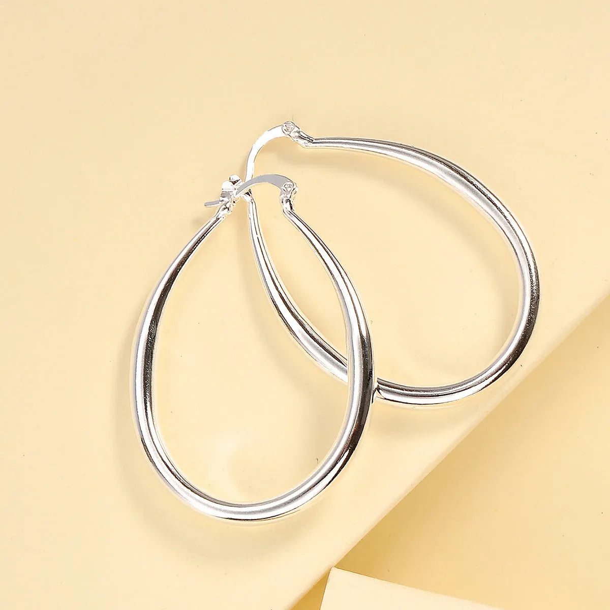 Geometric oval metal earrings for women with electroplated finish and alloy inlaid gems in gold and silver