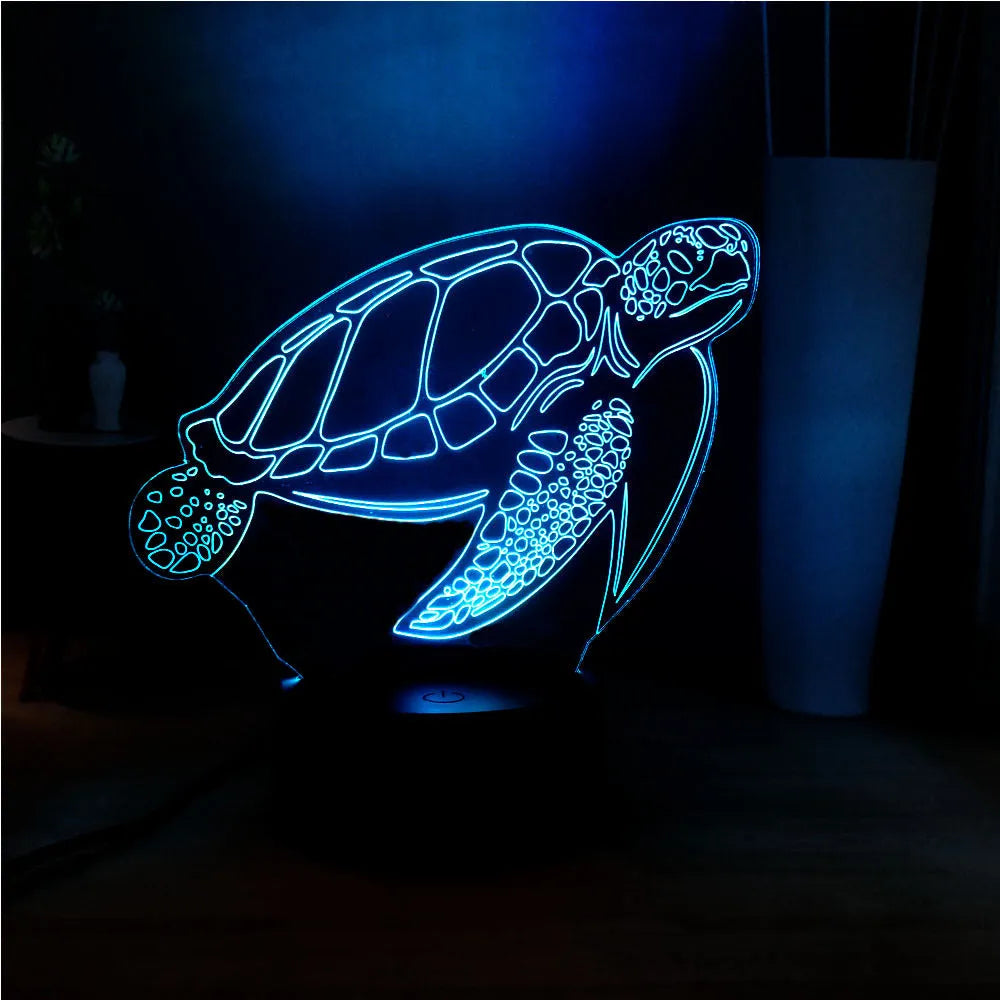 3D acrylic turtle-shaped LED night light with multi-colour illumination on a wooden surface.