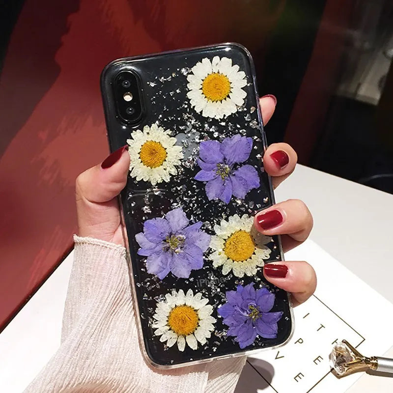 Clear iPhone case with dried pink Qianliyao flowers preserved in epoxy resin on transparent TPU back