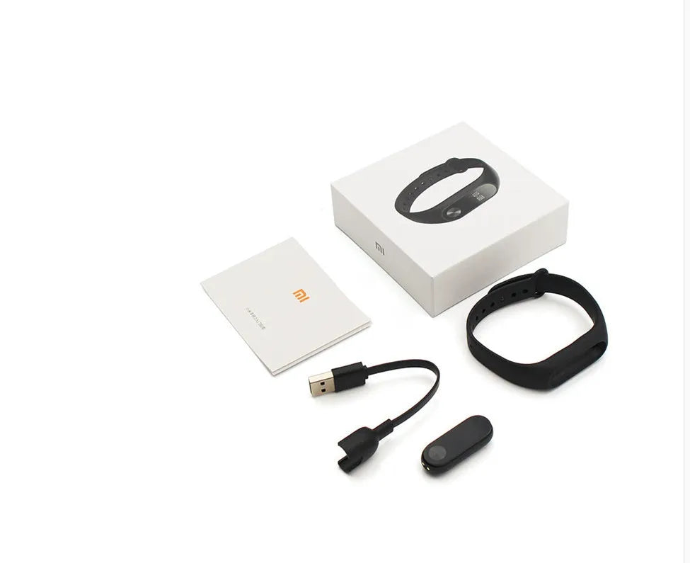 Black Xiaomi Mi Band 2 smart band with OLED display on a wrist, showing heart rate.
