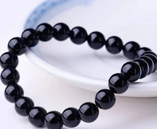 Black onyx bracelet with 8mm geometric beads on a stretchy elastic cord.