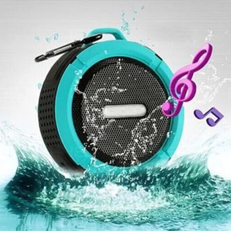 Compact waterproof Bluetooth speaker with a mounting clip, shown in blue.
