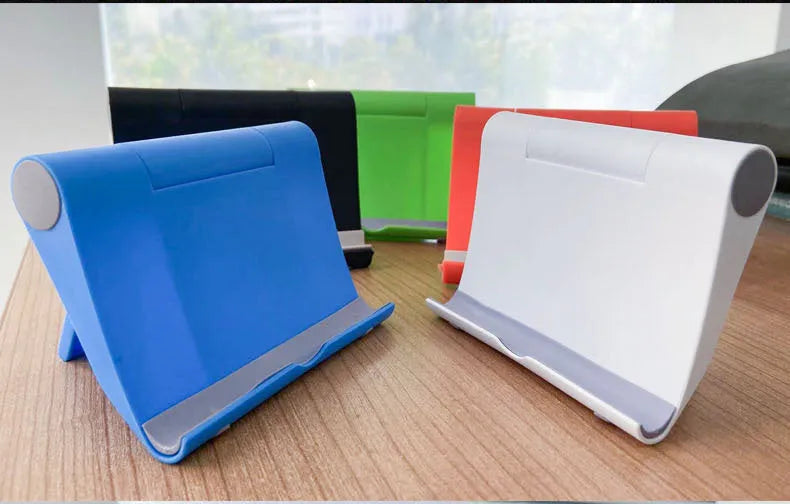 PE folding mobile phone stand in black on a wooden desktop, holding a tablet.